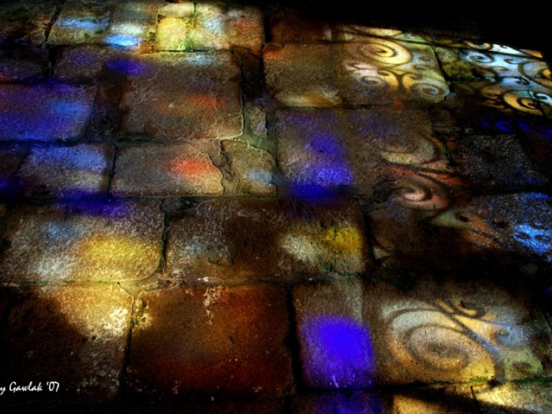 Medieval chapel floor with stained glass windowlight
