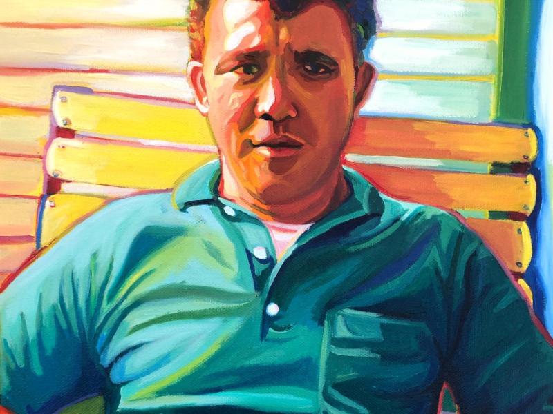 A technicolor up close portrait of a mid century man in his mid thirties. He's wearing a green polo and making eye contact with the camera. 