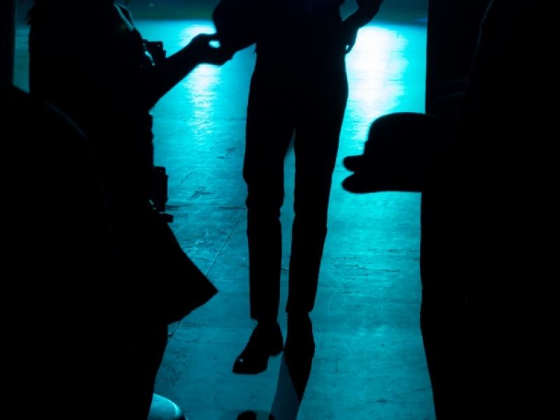 Silhouette of dancer exiting stage with spotlights