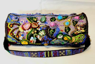 The purse is embroidered with beads using various natural semi-precious stones.