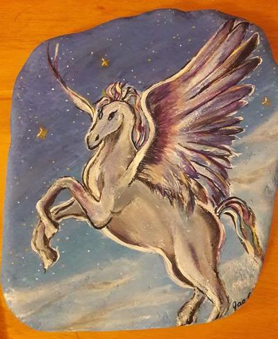 Fantasy Pegasus flying among the clouds and stars.