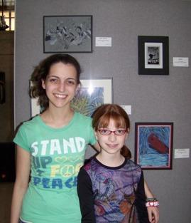 10th Annual Exhibit Sisters pose with their artwork