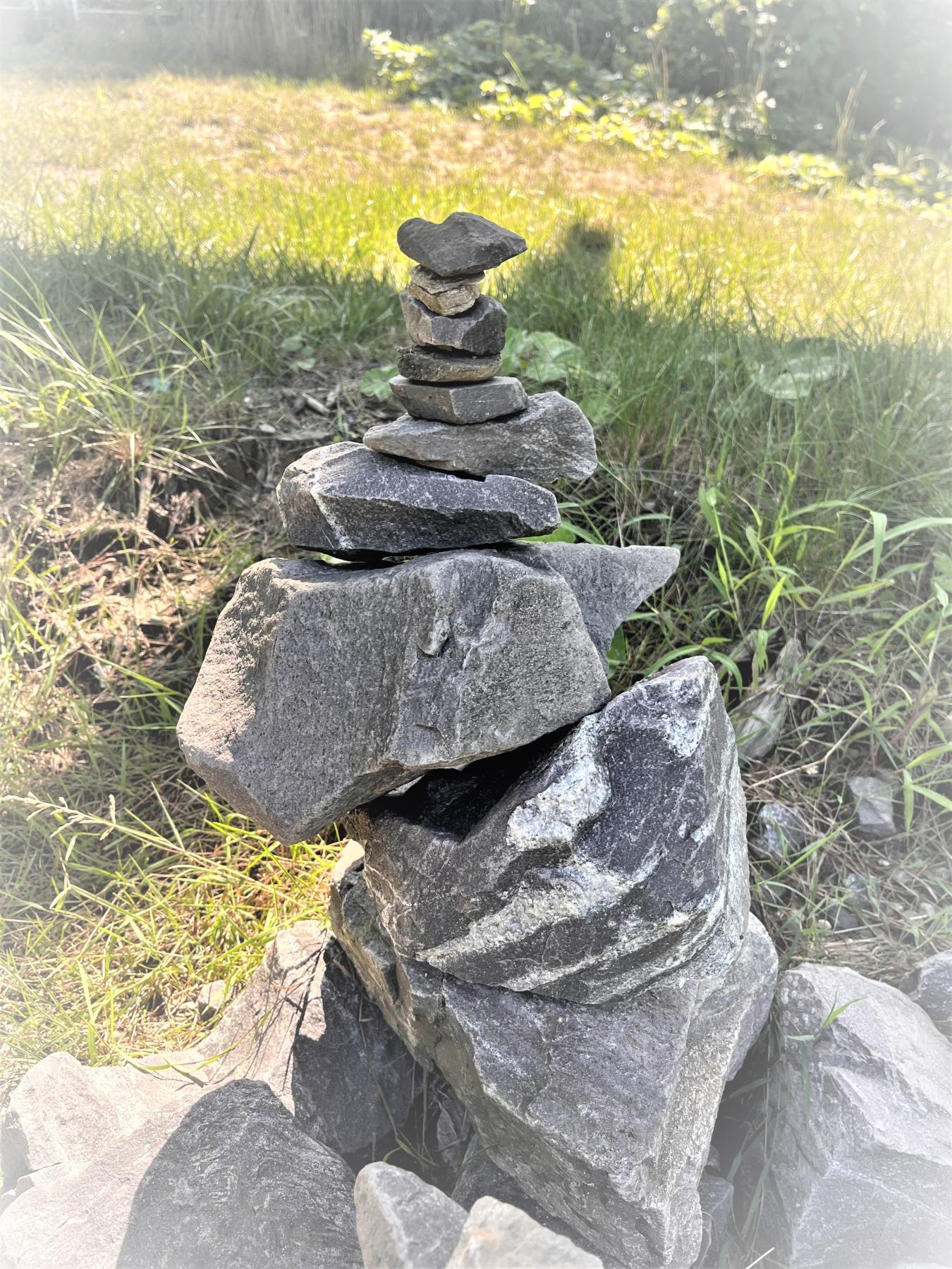 stones stacked by size on grass