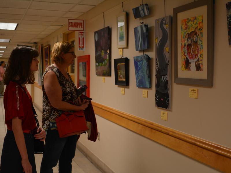 15th Annual Exhibit Attendees taking in the artwork at the Seminole County Services Building