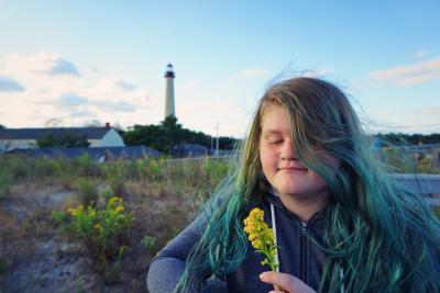 lighthouse, hair, goldenrod, sunset, flowers, girl, clouds, cape may