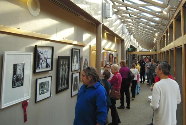 8th Annual Exhibit Attendees taking in the artwork on display at the Finley Community Center