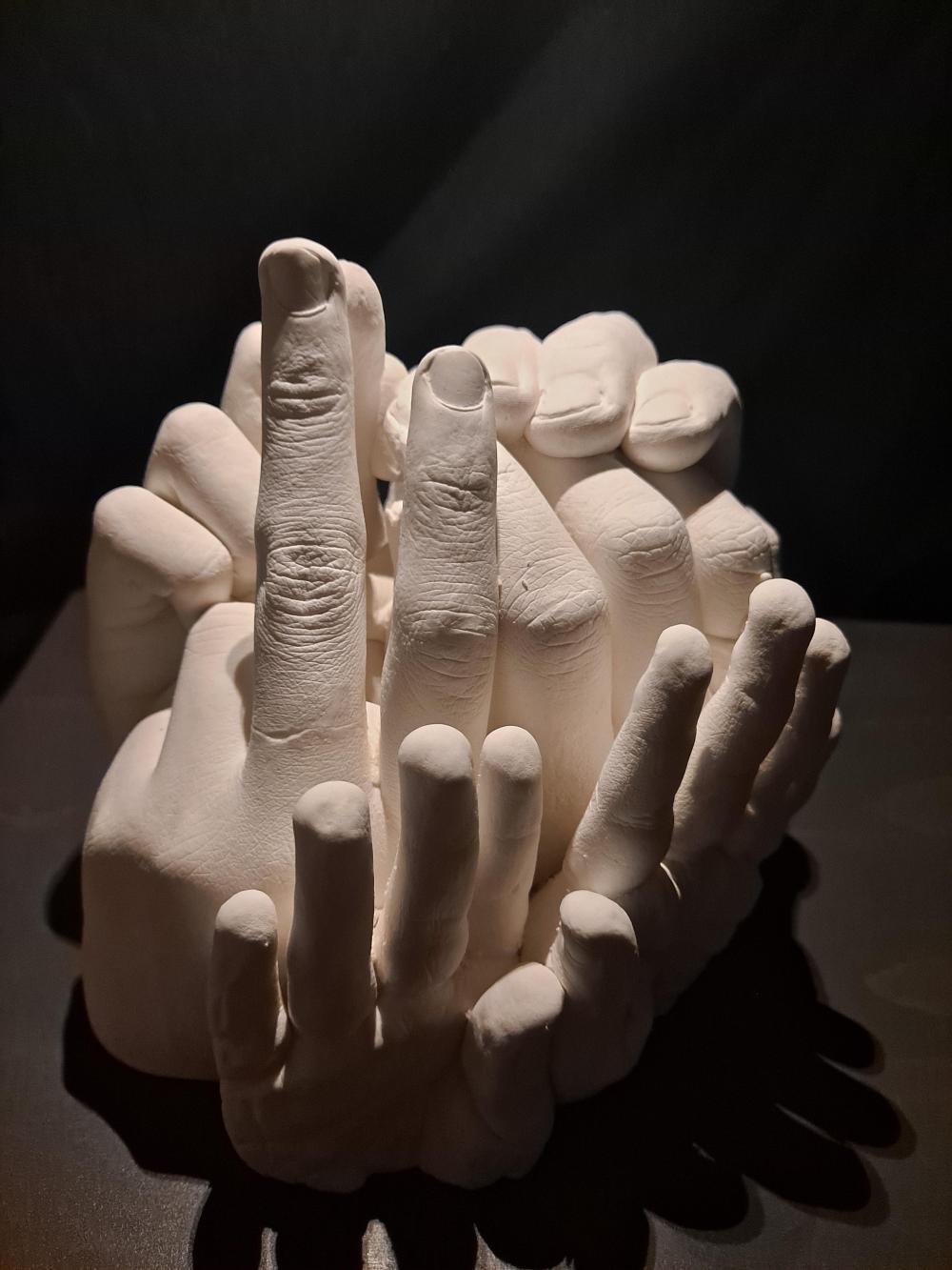 sculpture of many hands in different positions