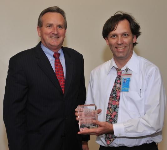 5th Annual Exhibit Coordinator Guy Bruggeman with Jeff Fegan, CEO, was presented the NAP's 5th Anniversary Award