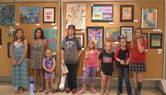 23rd Annual Exhibit Youth participants posing with their artwork at the awards reception in Lubbock, TX.
