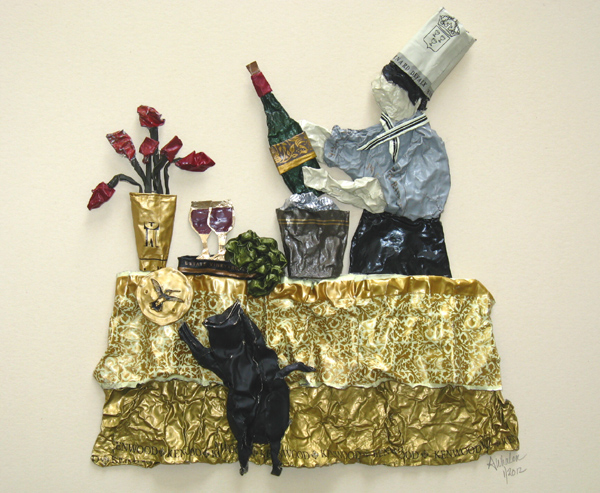 sculpture on paper of a chef and his unruly cat, made entirely from wine capsules